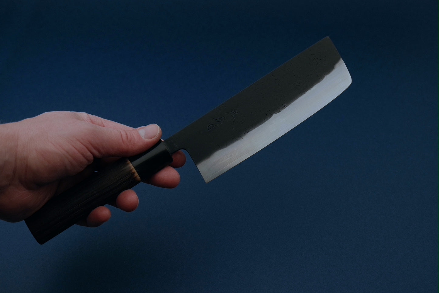Tadafusa black nashiji SLD nakiri with a burned chestnut oval handle and buffalo horn collar 165 mm