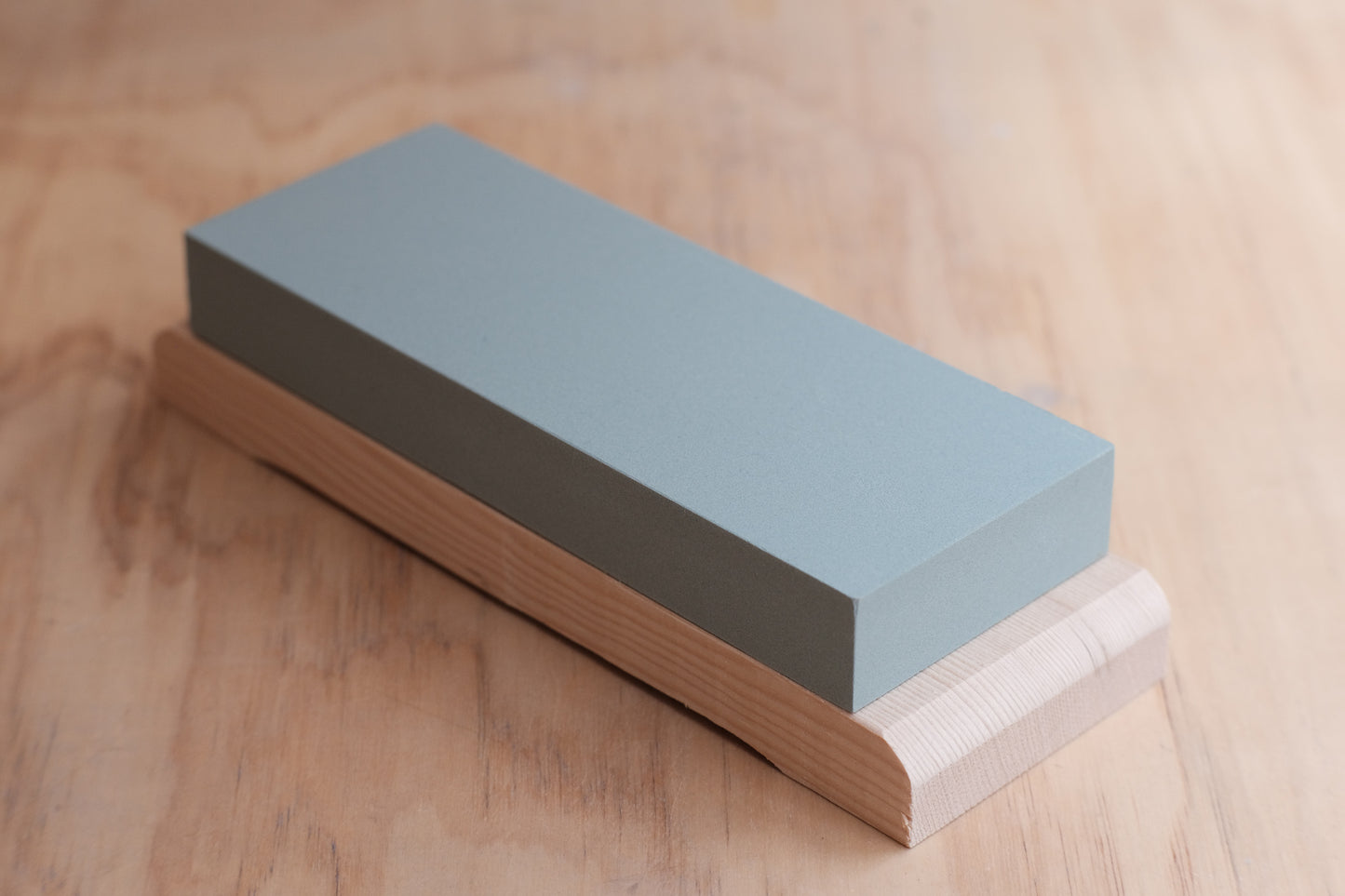 Vitrified ceramic silicon carbide whetstone 400 grit on a wooden base